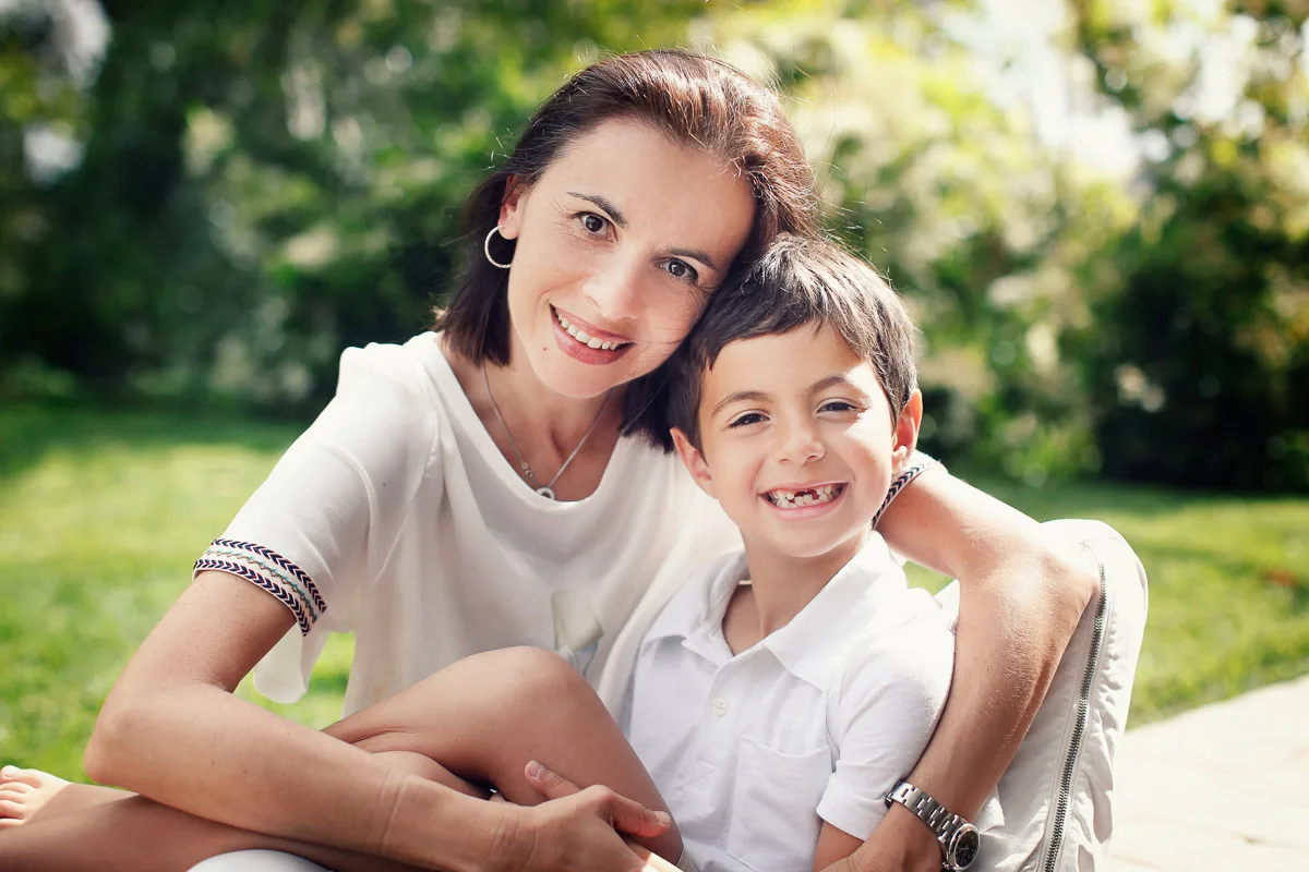 Clara and Jess sitting together in the garden during an at-home family photoshoot in Singapore
