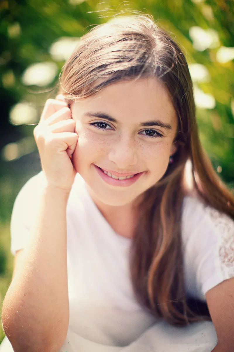 Hannah resting her chin in her hand during an individual portrait at home