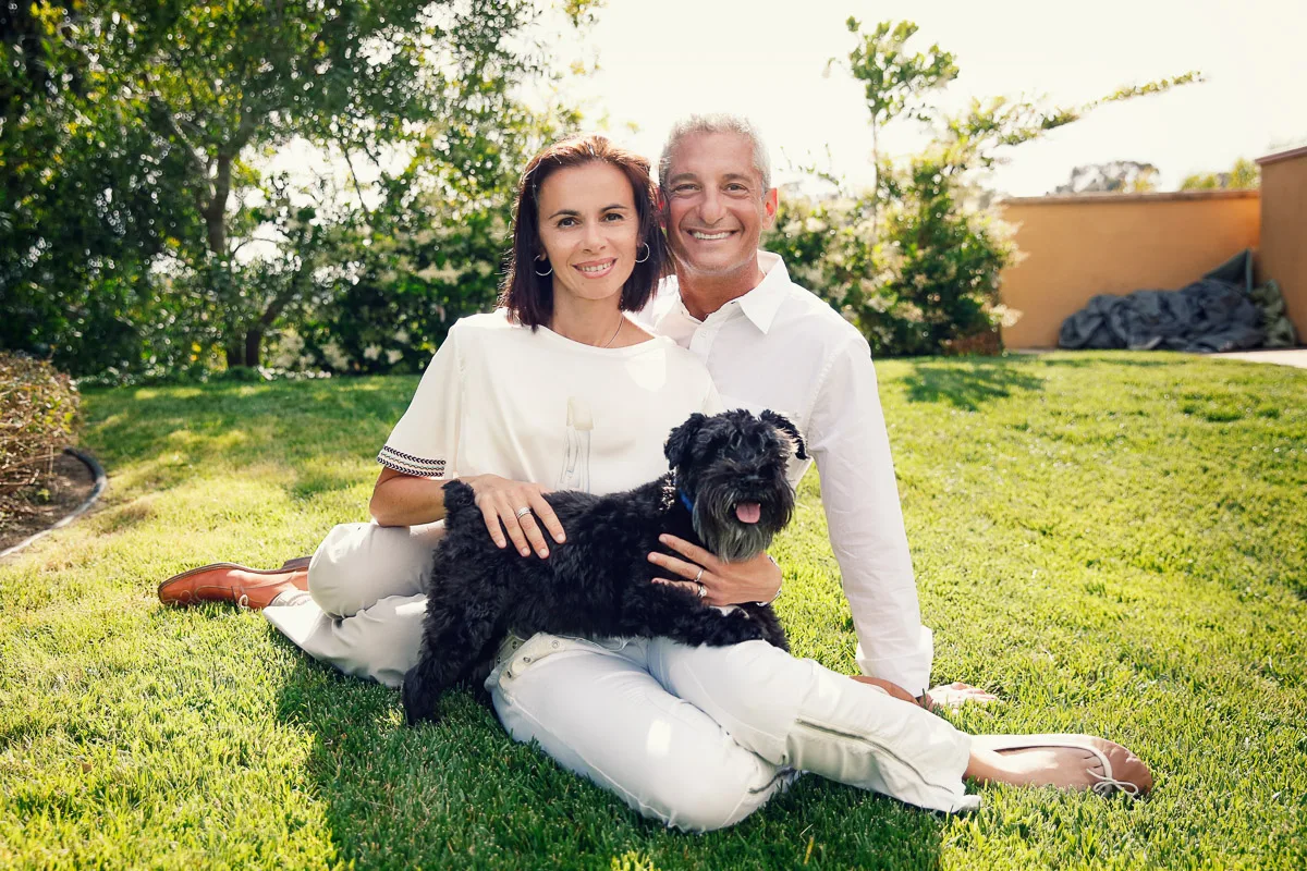 Rob and Clara sitting on the lawn with their dog during a Singapore home family photoshoot