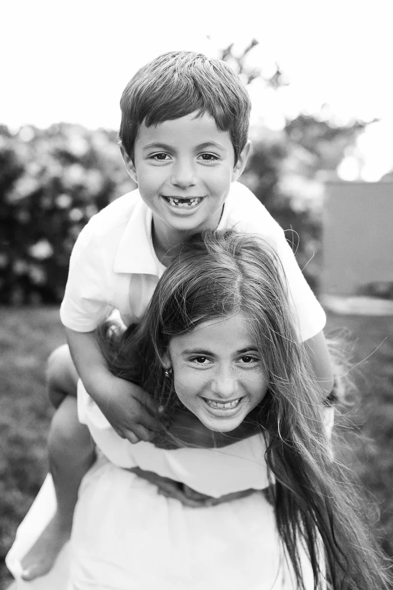 Black and white portrait of Jess and Hannah playing together during their family session