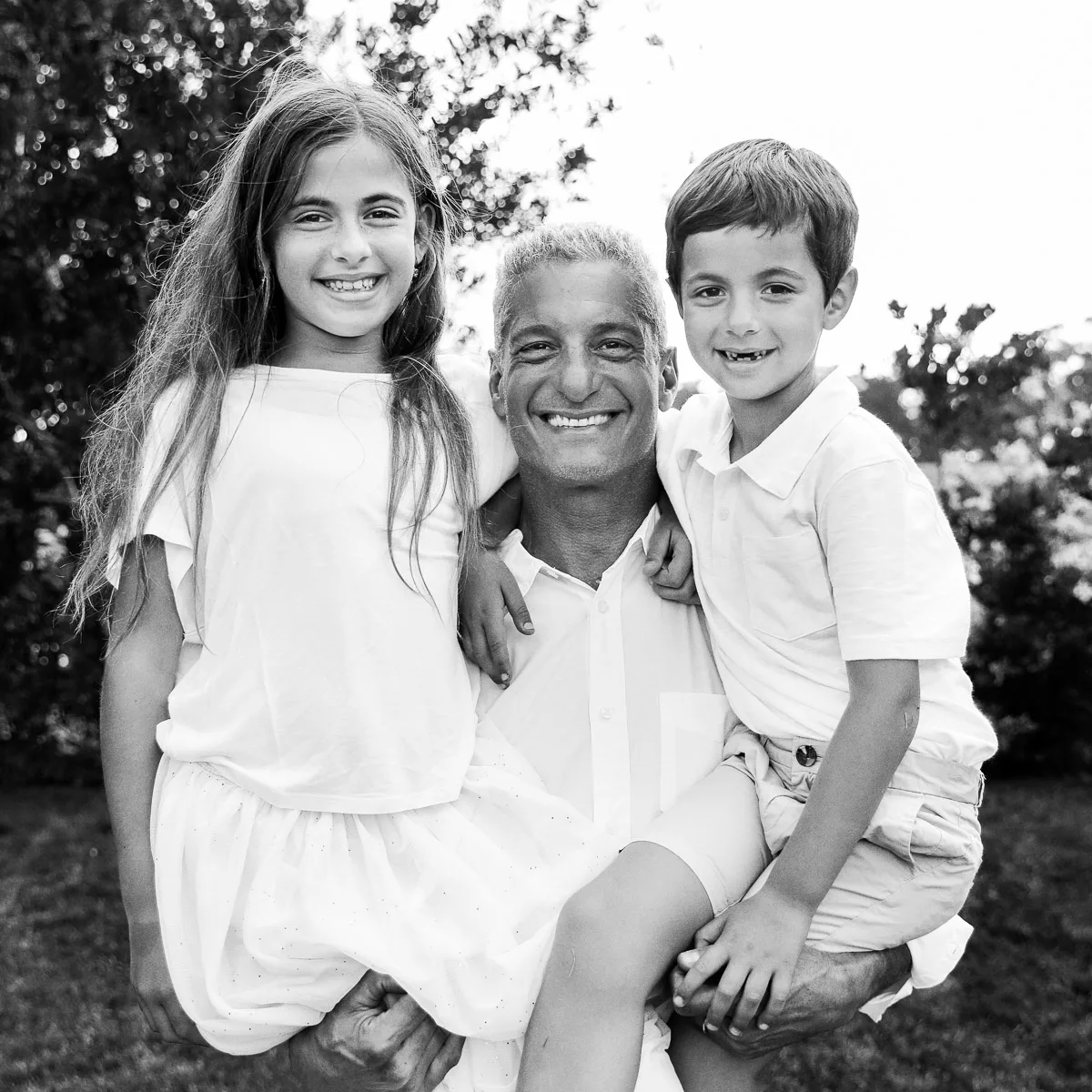 Black and white portrait of Rob with Jess and Hannah in the garden