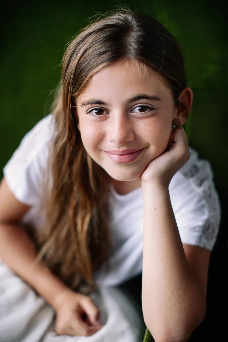 Hannah smiling during an individual portrait at home in Singapore