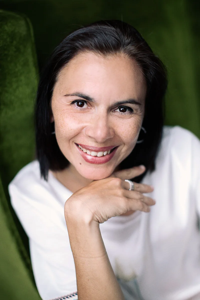 Clara smiling during an individual portrait at home in Singapore