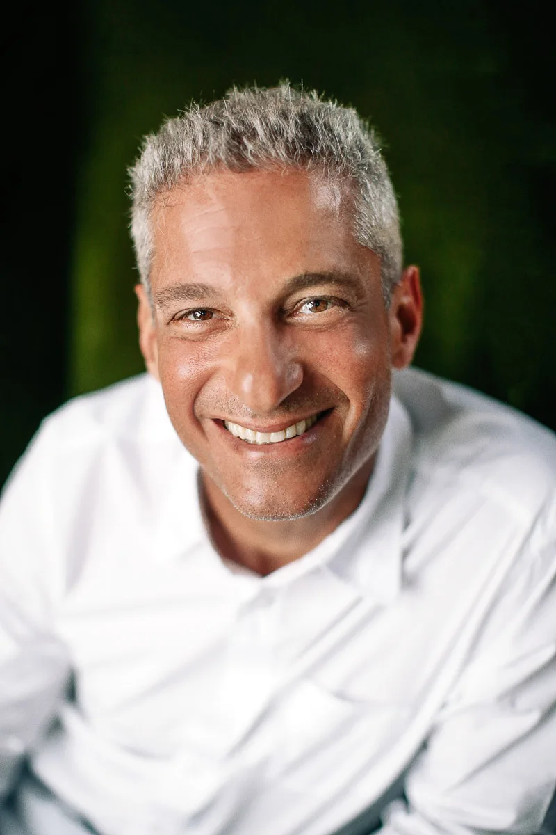Rob smiling during an individual portrait at home in Singapore