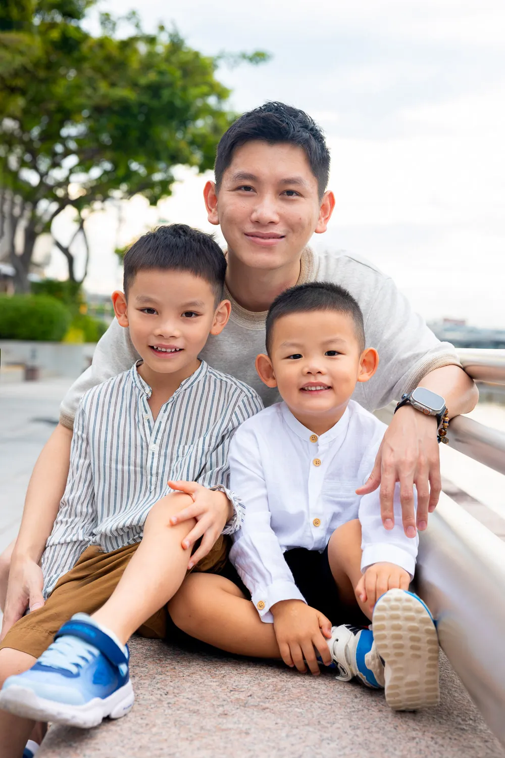 Family walking together along the Marina Bay waterfront at sunrise in Singapore