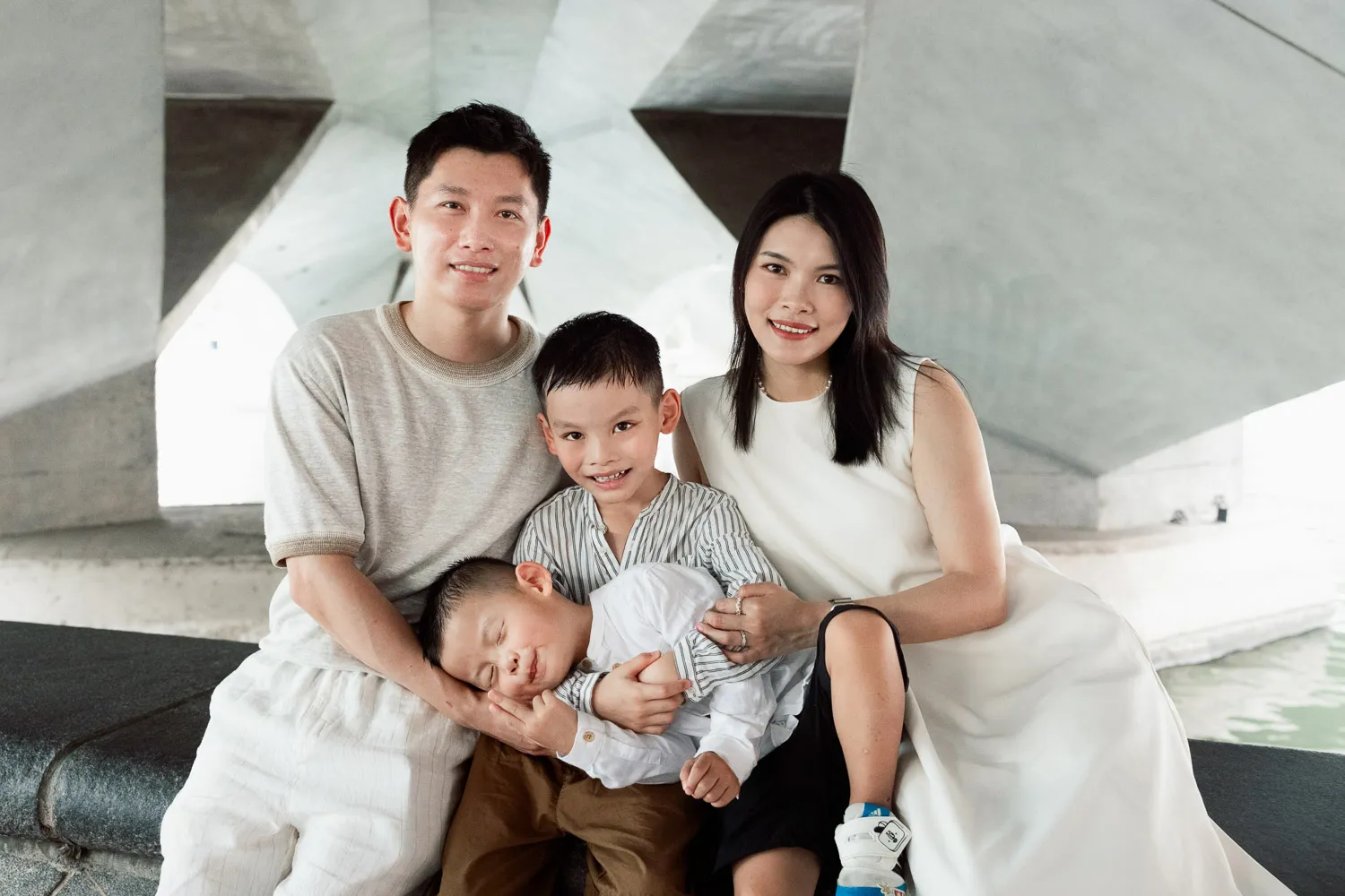 The Singapore skyline glowing behind Jay, Yan, Lucas and Louis