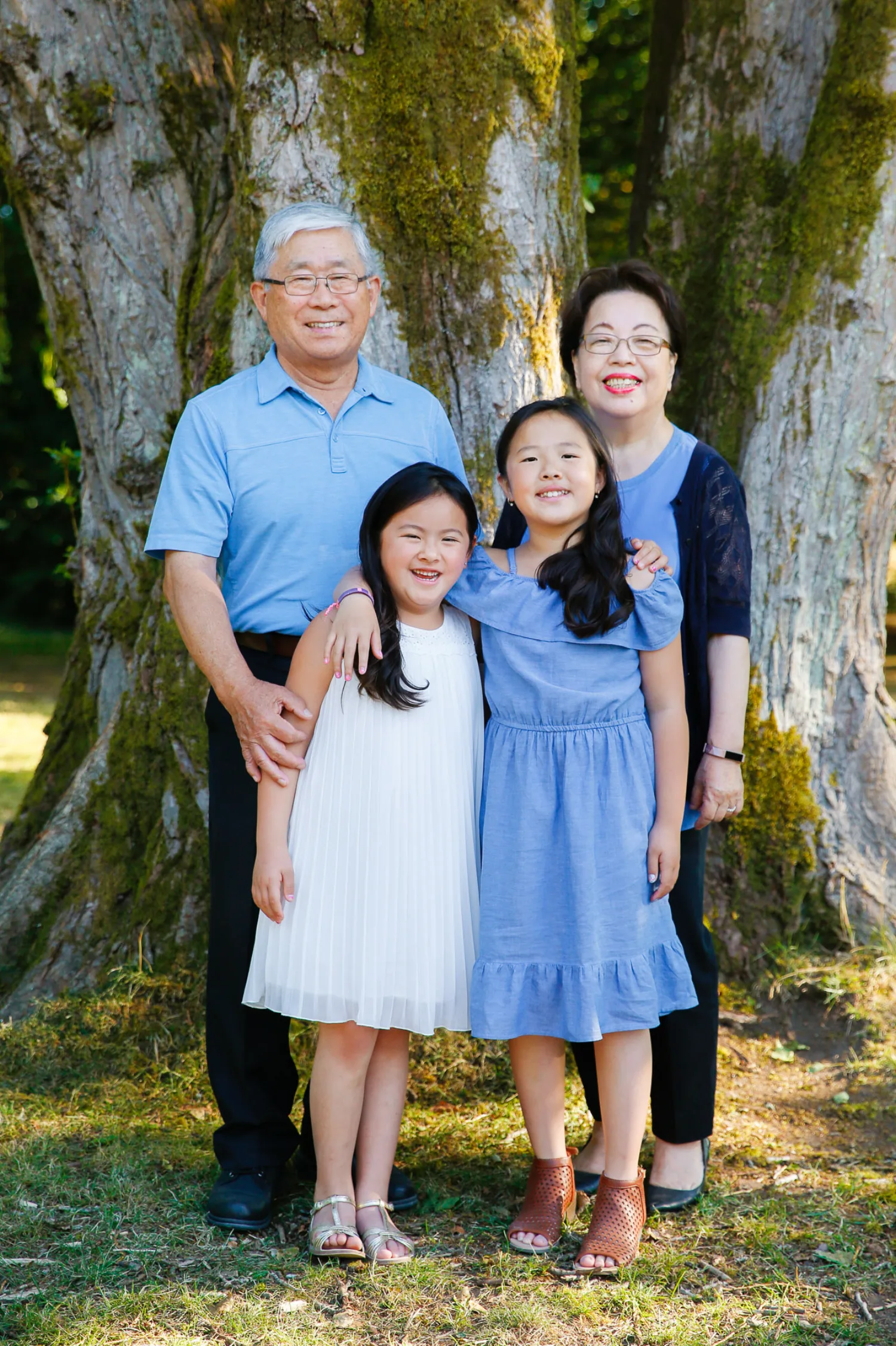 Grandparents with two young sisters during a Vancouver beach family session