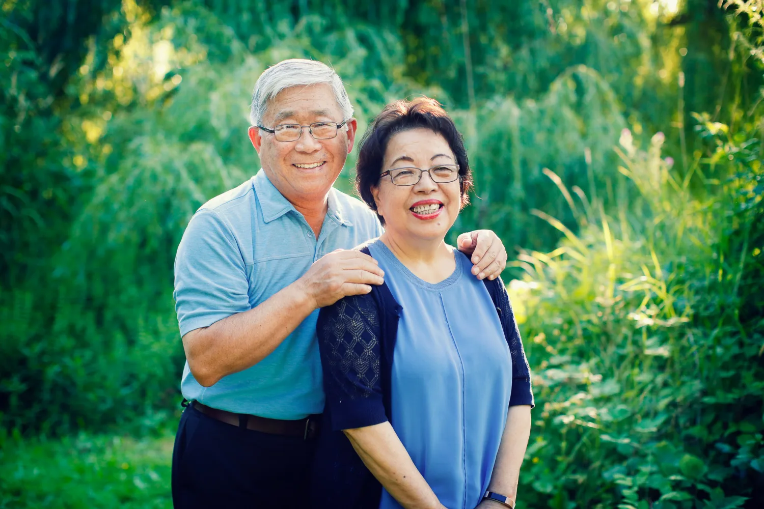 The family gathered together near the driftwood on the beach