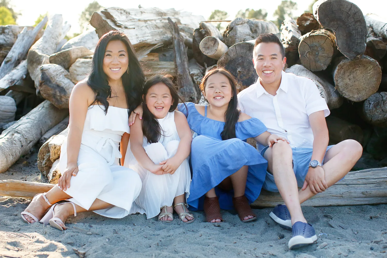 The girls walking the beach with their parents in the morning light