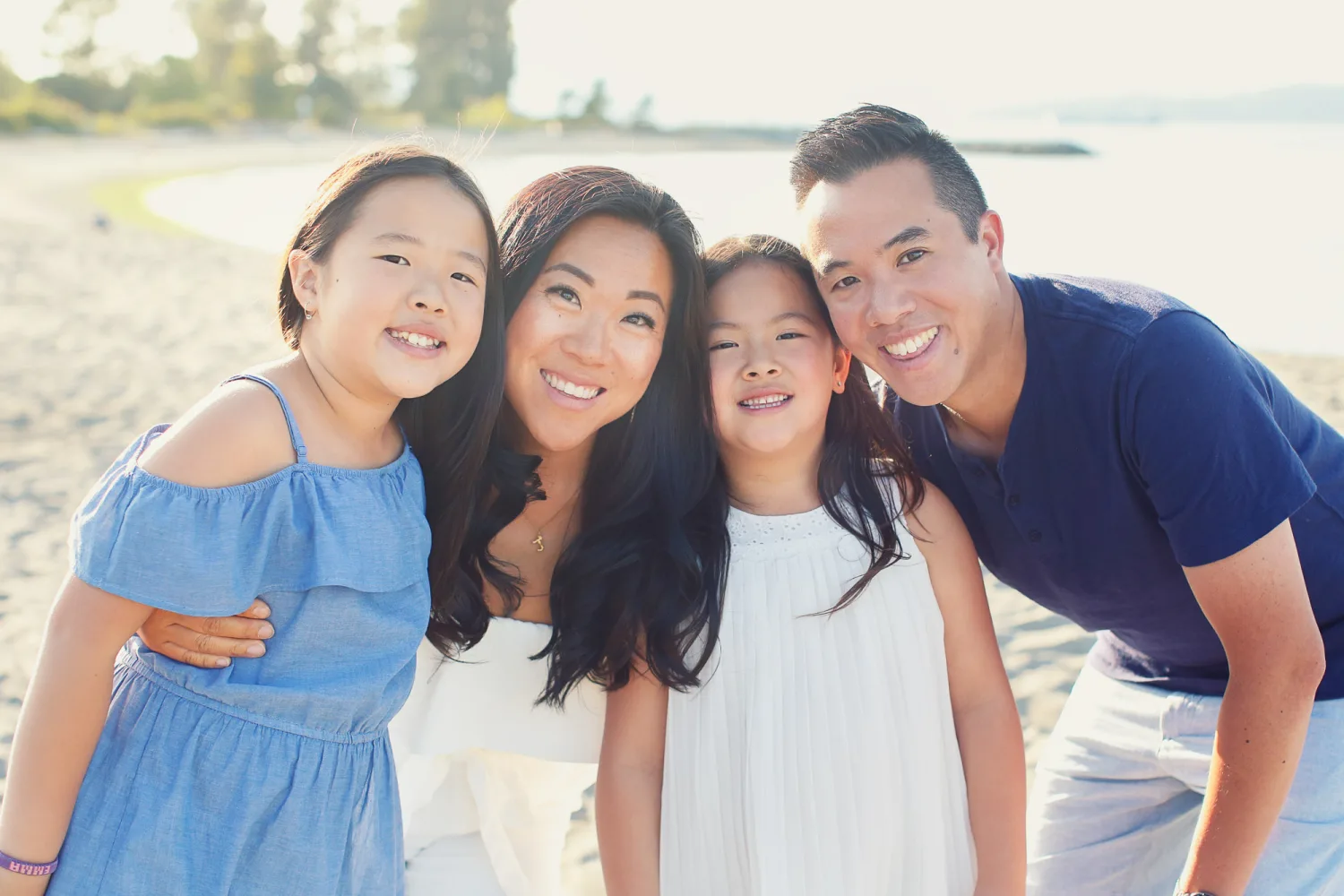 The family walking together across the sand in Vancouver