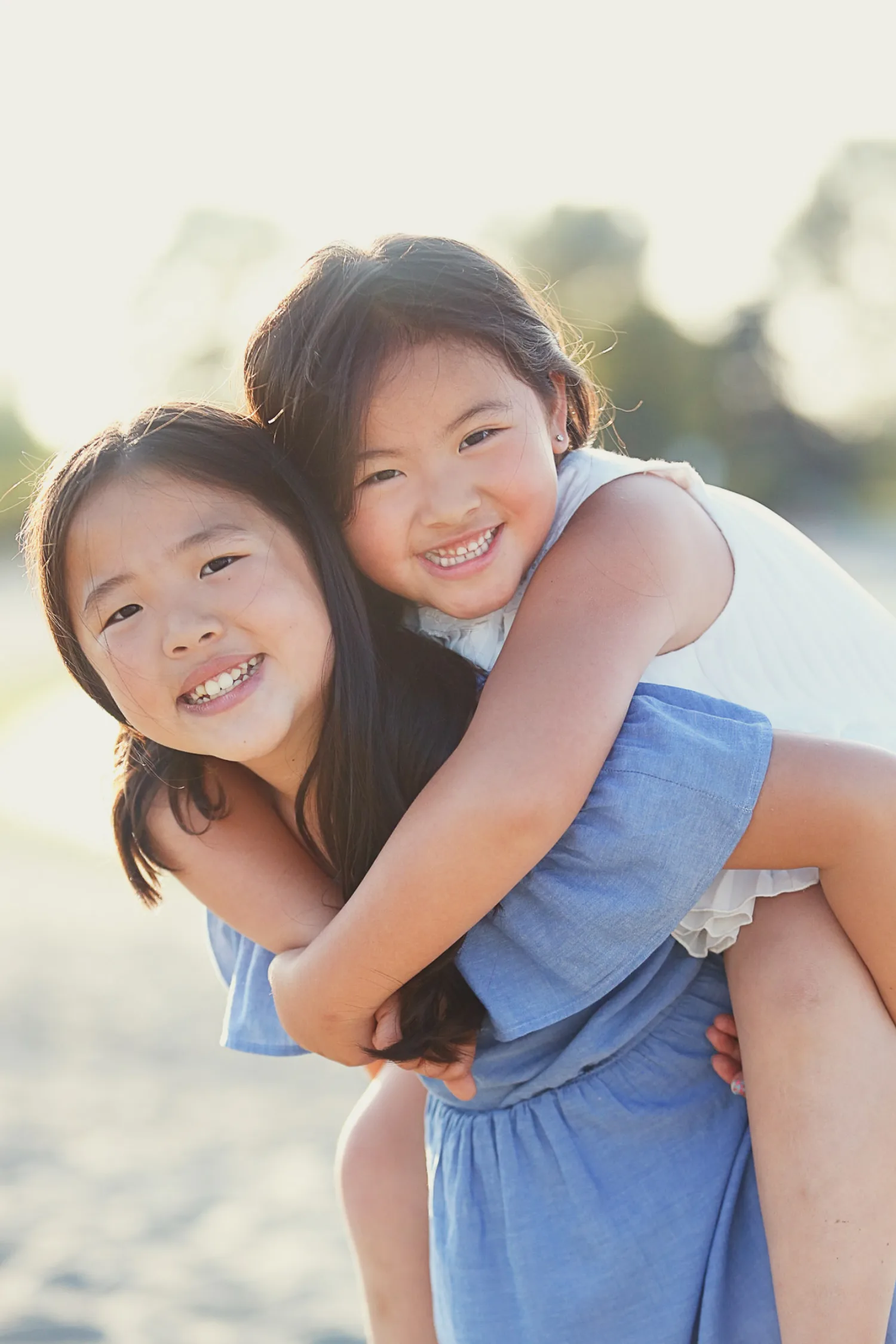 One sister carrying the other during the Vancouver beach family session