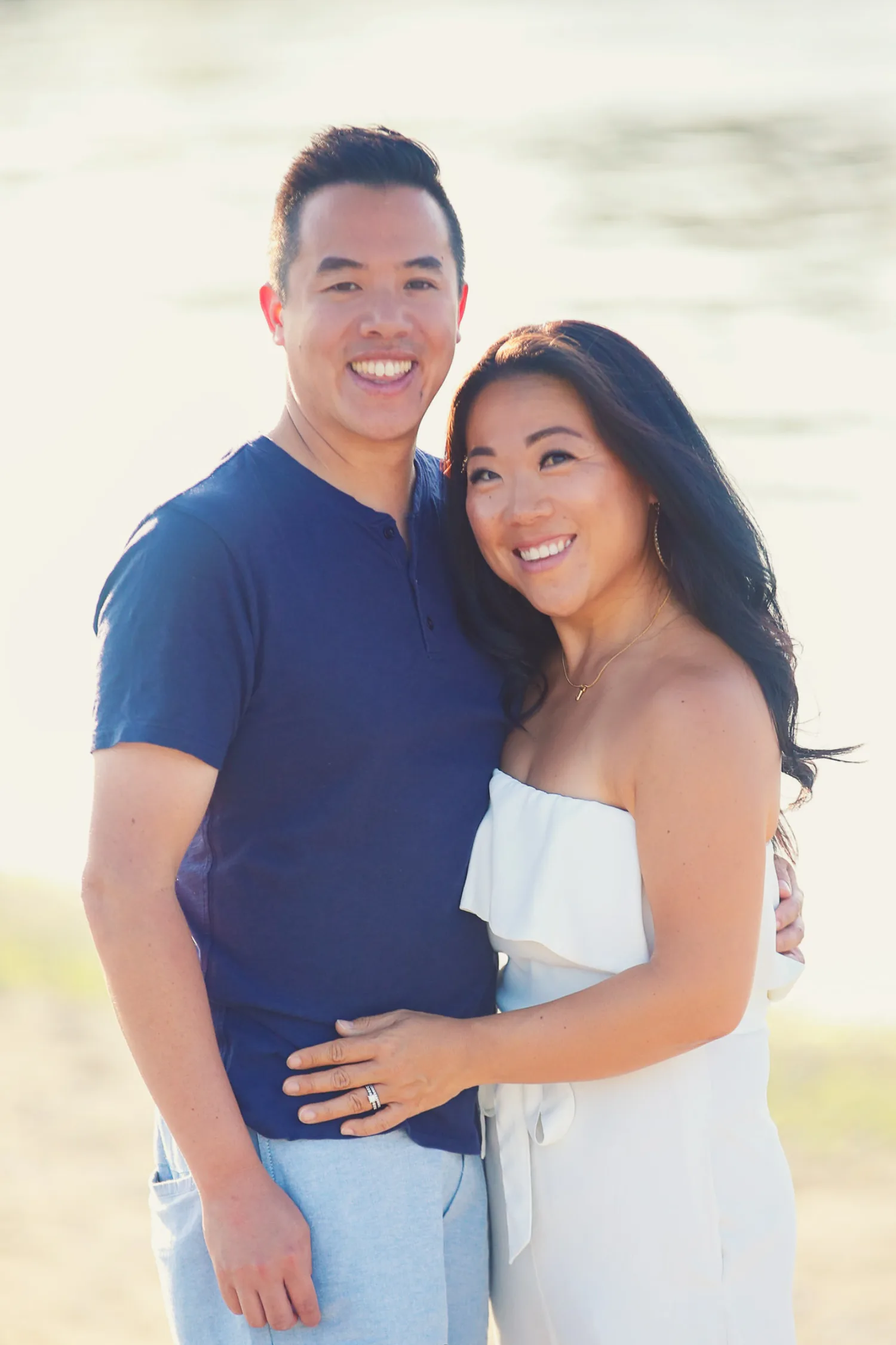 Jen and Evan smiling together during their Vancouver beach family session