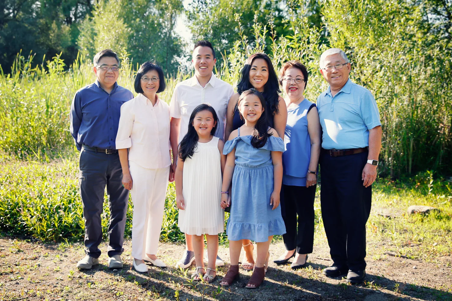 Jen, Evan and their daughters together on the beach in Vancouver