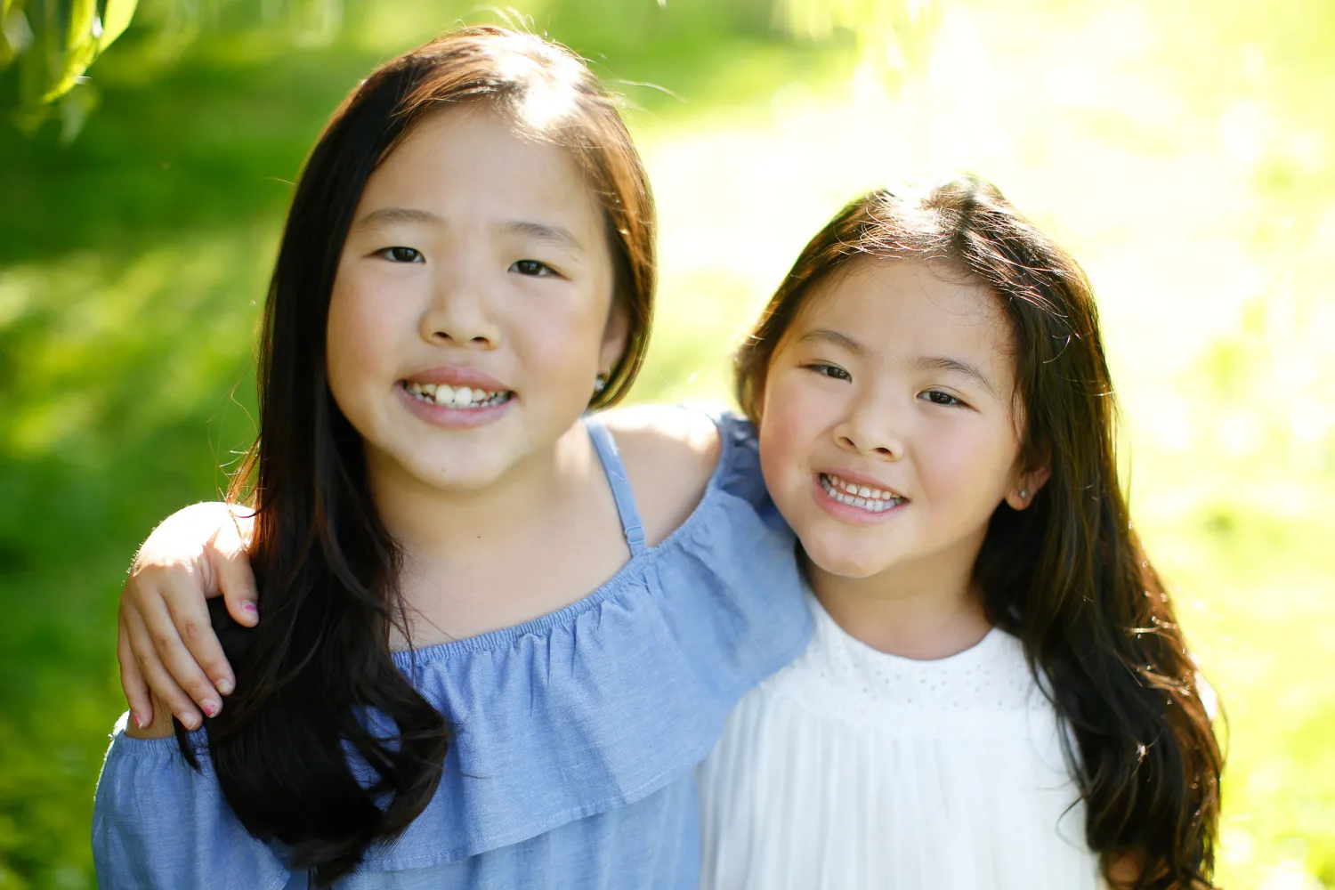 Two sisters together during a Vancouver beach family session