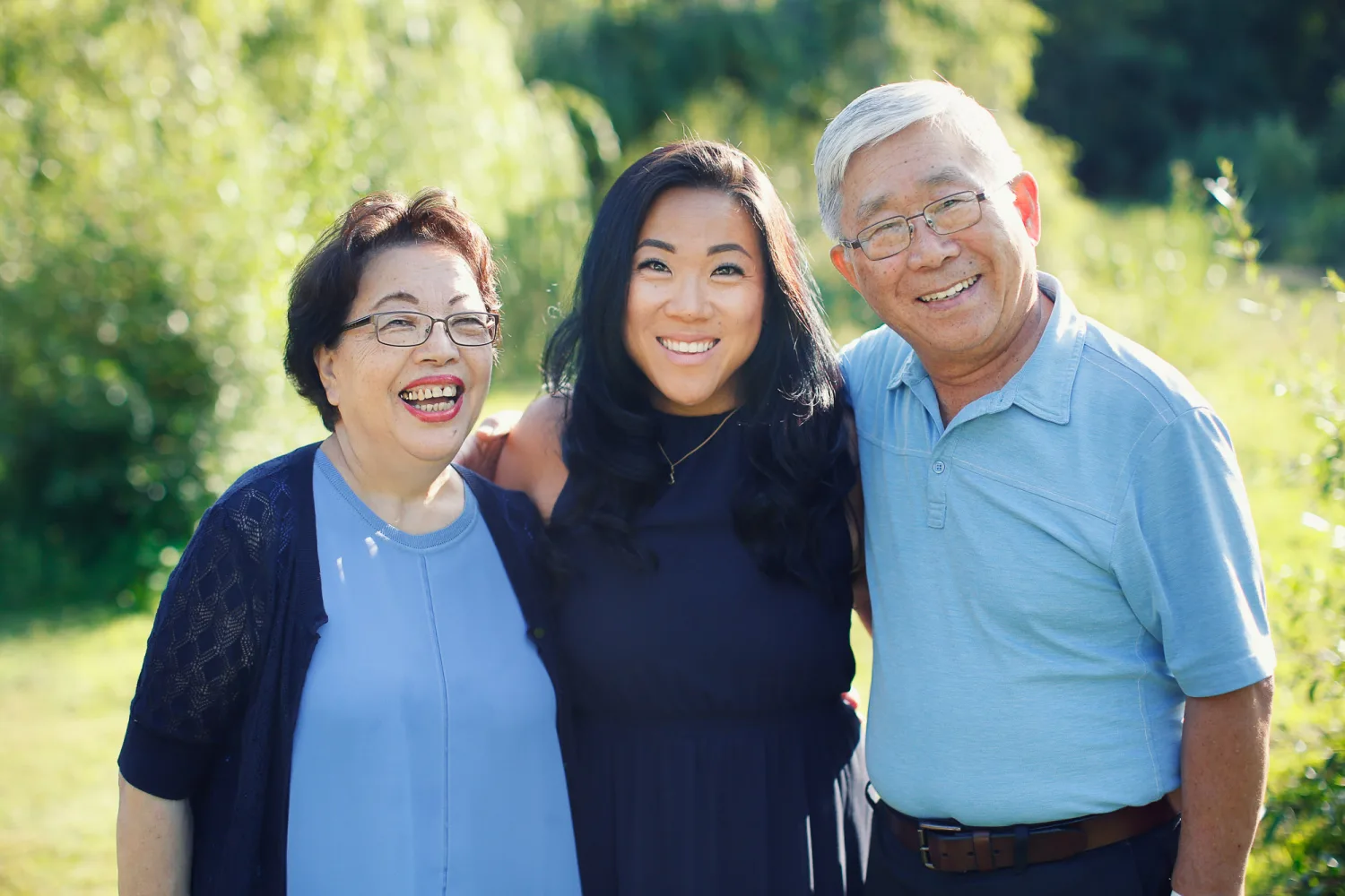 Portrait of the sisters together by the driftwood at the beach