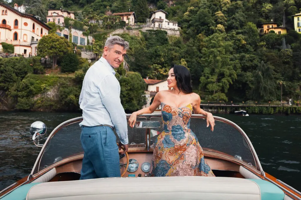 Vera and Emilio on the lake in a Lucia boat, the hills of Como rising behind them