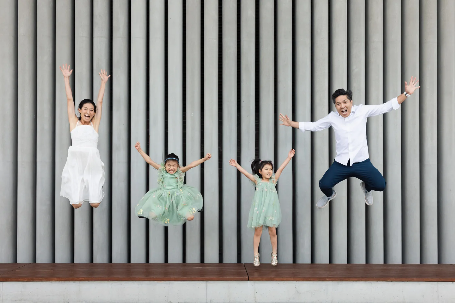 Terence, Suzanna, Sophie, and Zoe leaping into the air with arms raised and big smiles