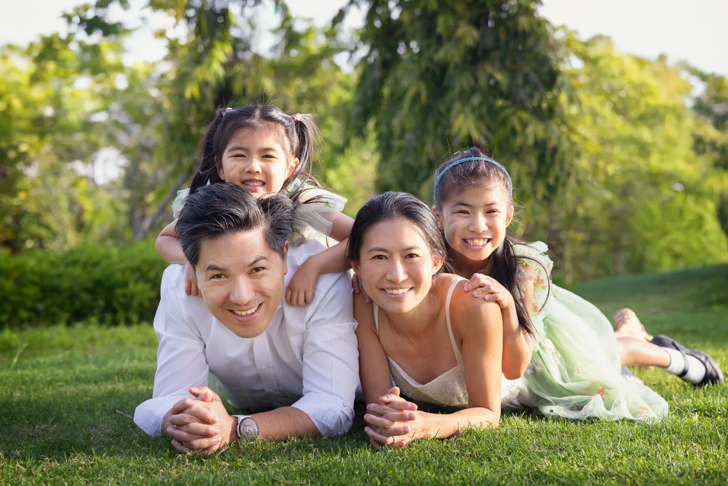 The family lying on the grass together with Zoe on Terence's back, everyone laughing