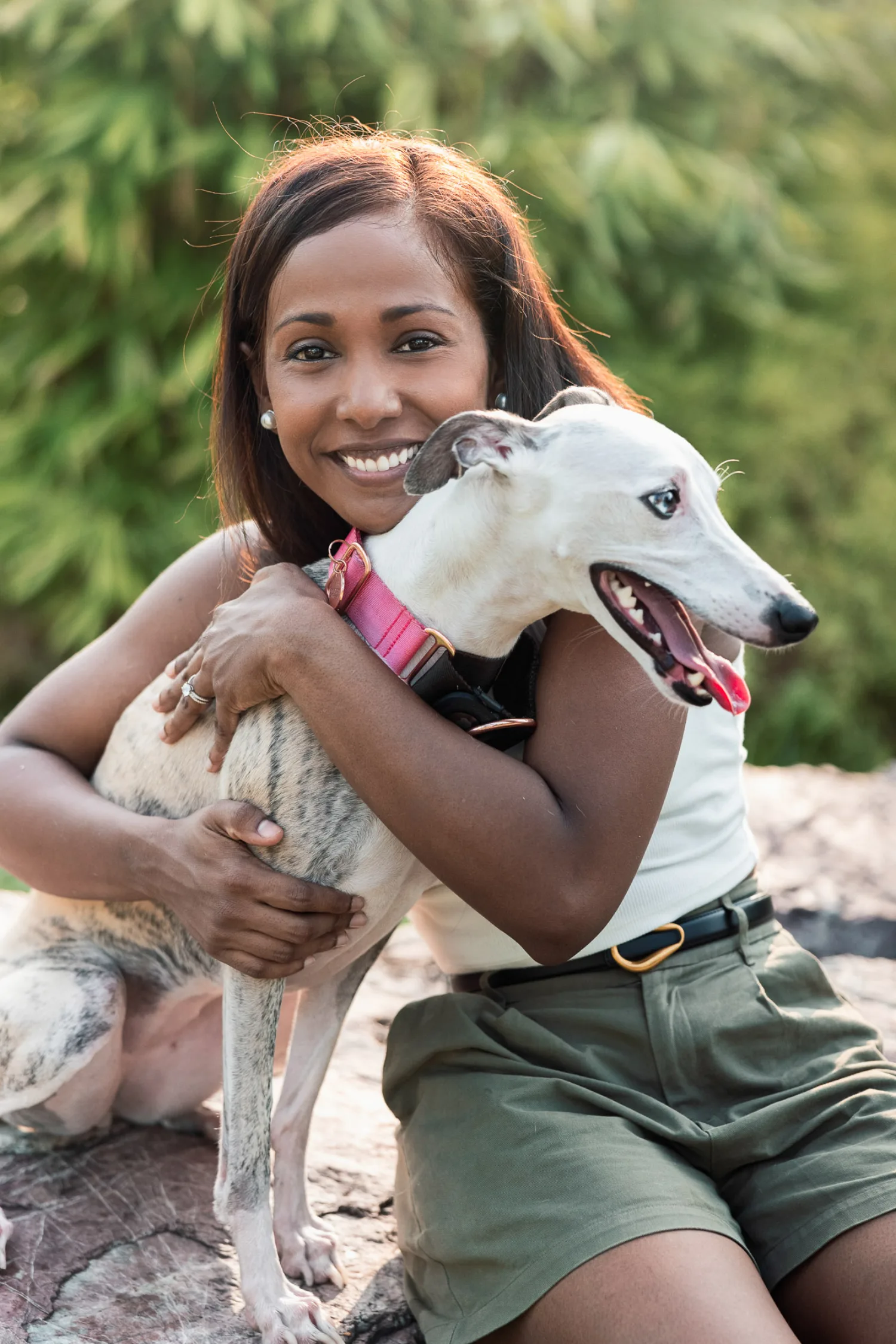 Jessica wrapping her arms around Luna on a warm rock in the golden light