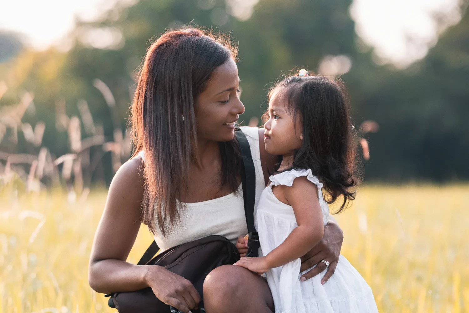 Jessica and Gabby gazing at each other in warm golden light