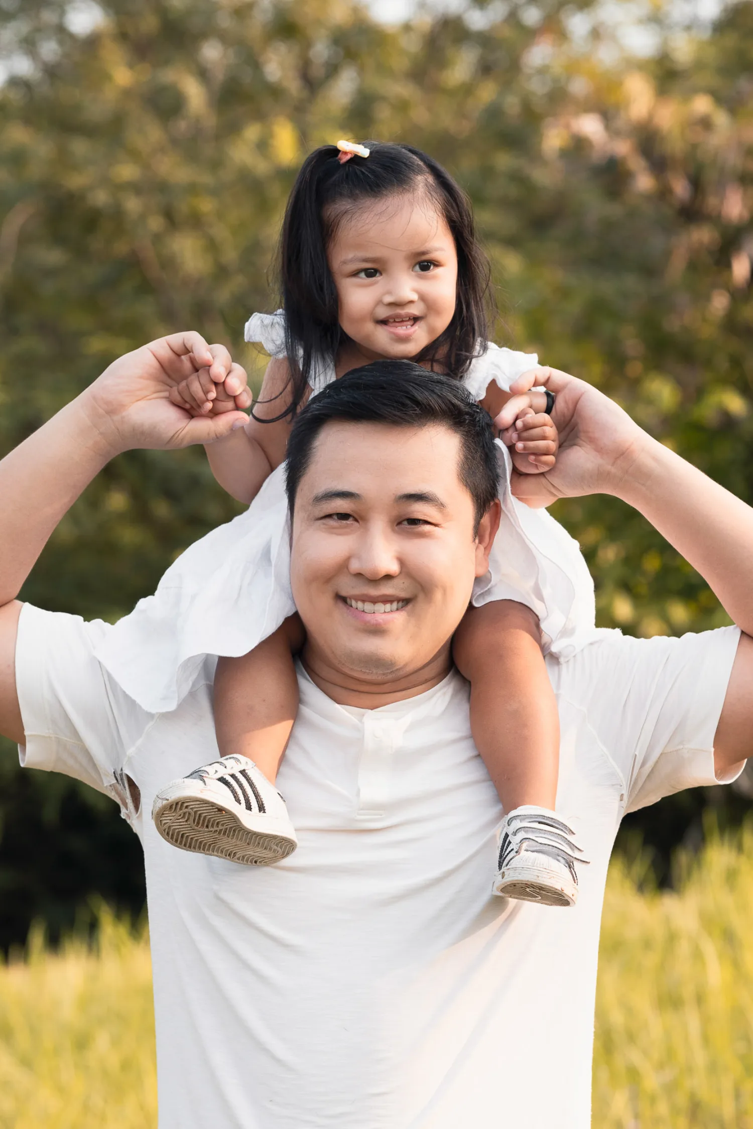 Dan giving Gabby a shoulder ride, both grinning broadly
