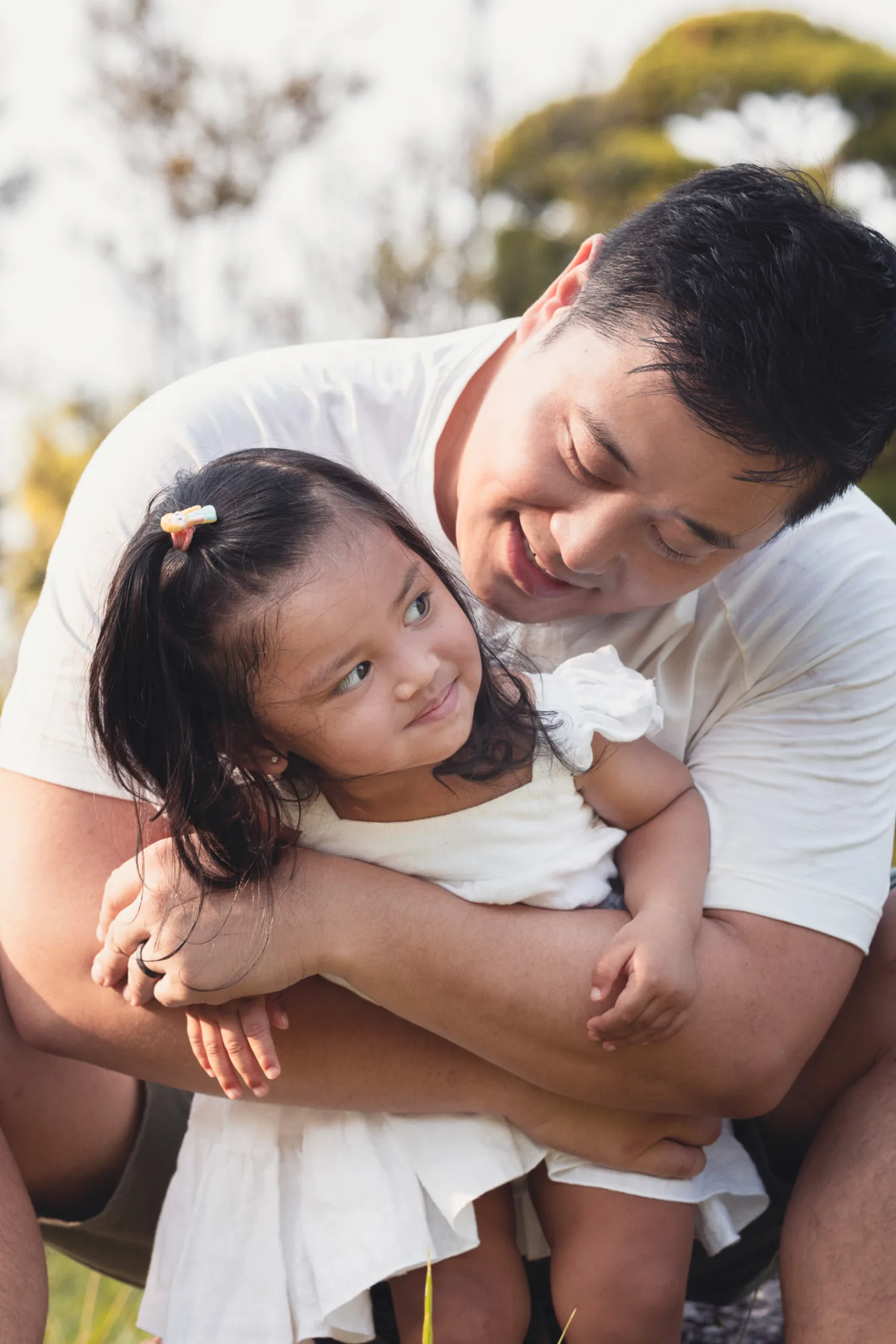 Dan and Gabby in a tender embrace in soft golden light